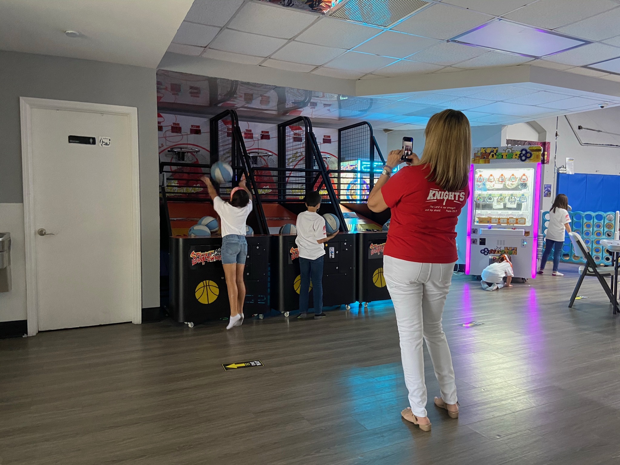 Kids playing basketball arcade shootout machines at All Star Party World